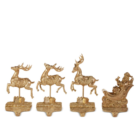 Santa and Reindeer stocking holders in gold at shoptreeboutique.com